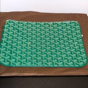 Green Goyard clutch.